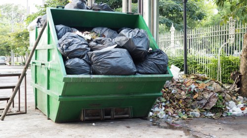 Local skip hire service provider assisting a customer in Whitechapel
